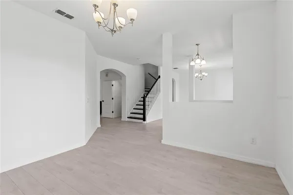 a view of an empty room with a ceiling fan