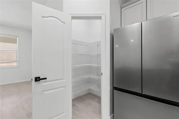 a kitchen with stainless steel appliances granite countertop a refrigerator a sink and a stove