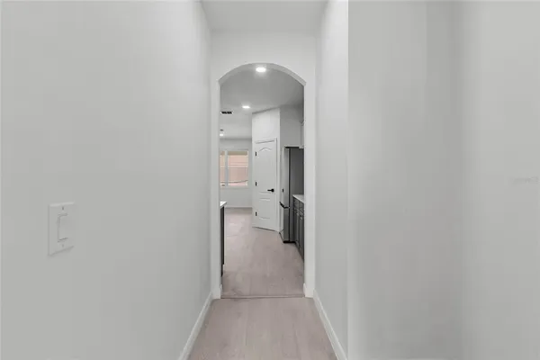 an empty room with a window and a chandelier