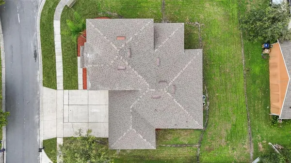 an aerial view of a house with a yard