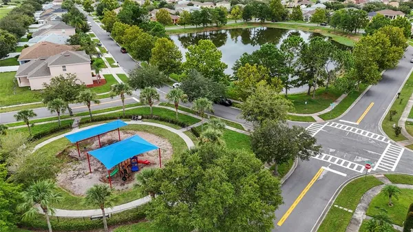 an aerial view of a house with a yard and lake view