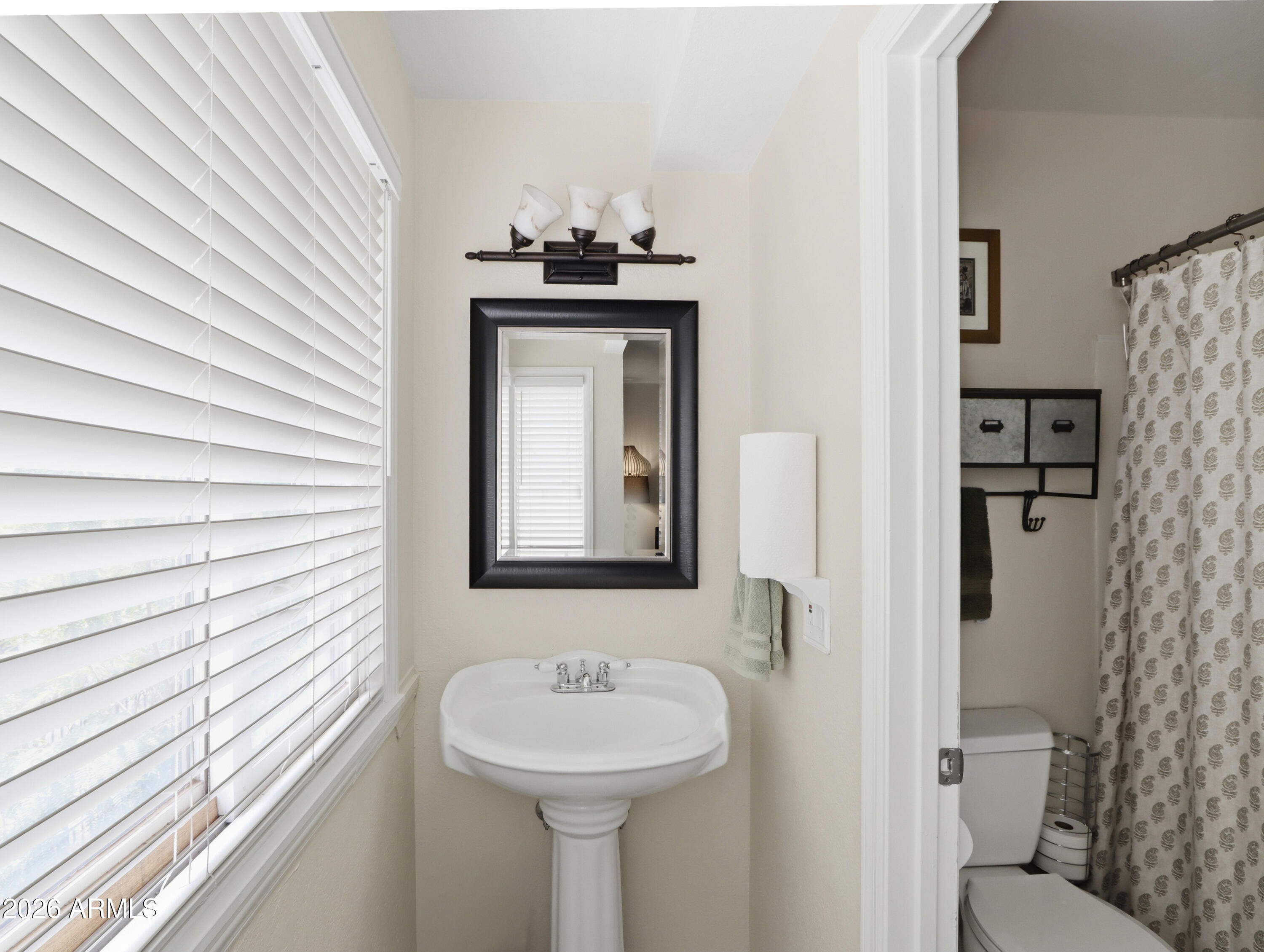 1402 East Osborn Road, Unit 2 Phoenix, AZ 85014 - Photo 18 of 29 a bathroom with a toilet sink and mirror