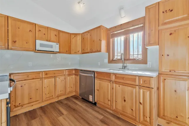 a kitchen with a sink a stove and cabinets