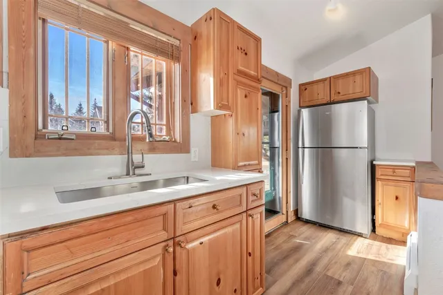 a kitchen with stainless steel appliances granite countertop a refrigerator and a sink