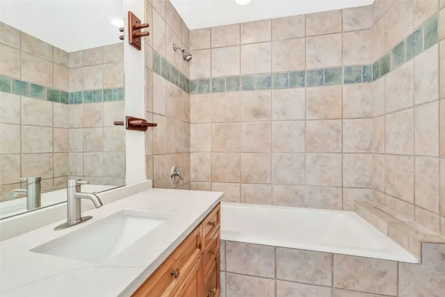 a bathroom with a bathtub and a sink