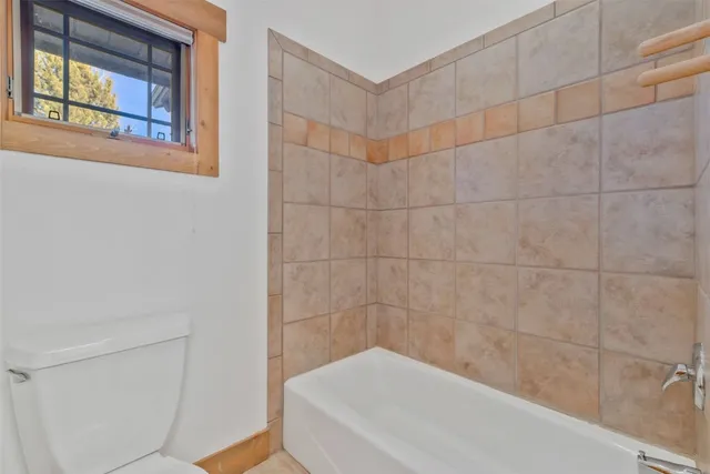a bathroom with a bathtub and window