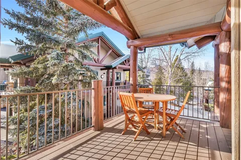 a view of a chairs and table in the balcony