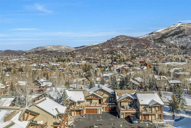 a view of a large building with mountains in the background