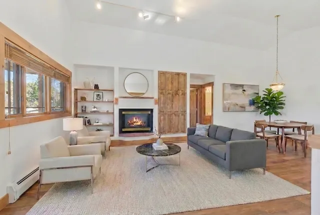 a dining room with furniture and wooden floor