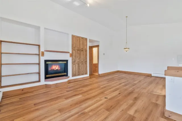a view of a kitchen with wooden floor and electronic appliances