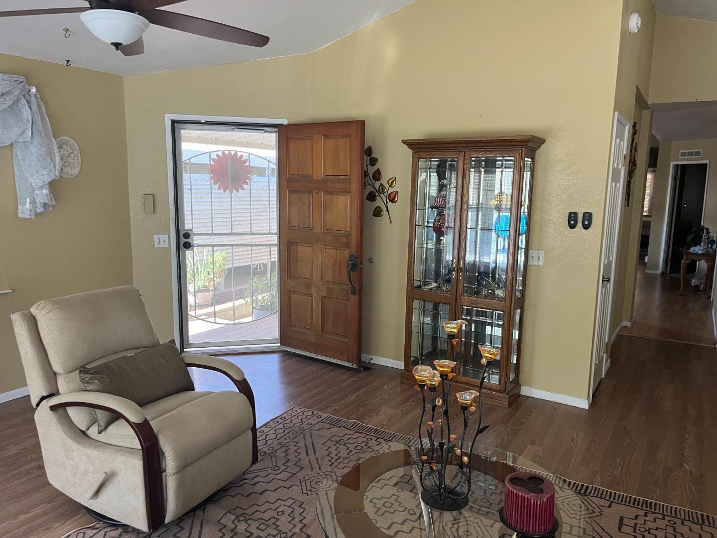 500 North Tully Road, Unit 39 Turlock, CA 95380 - Photo 5 of 23 a living room with furniture a chandelier and a window