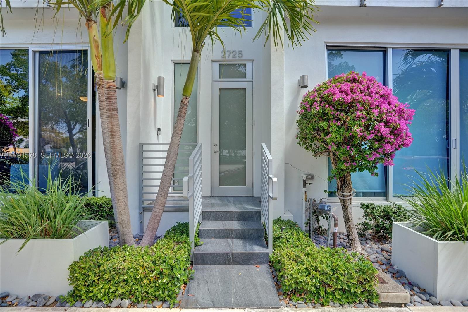 2725 Northeast 1st Street Pompano Beach, FL 33062 - Photo 11 of 59 a front view of a house with garden