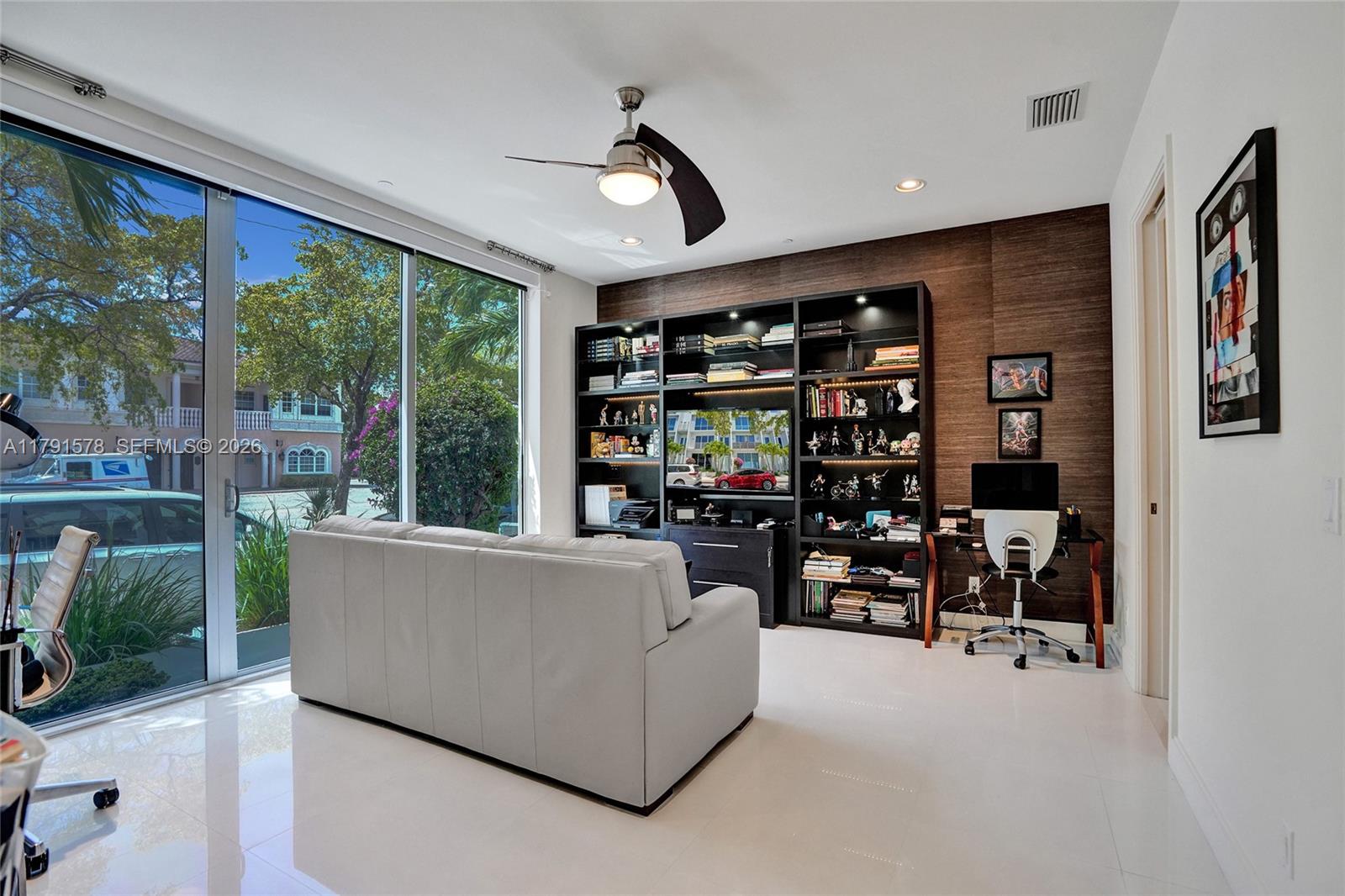 2725 Northeast 1st Street Pompano Beach, FL 33062 - Photo 13 of 59 a living room with couch and a bookshelf