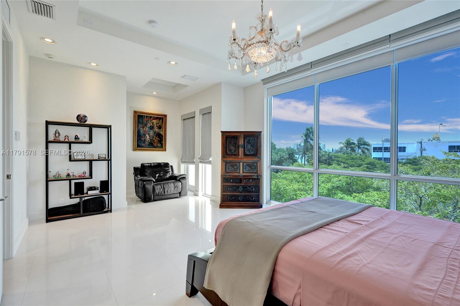 2725 Northeast 1st Street Pompano Beach, FL 33062 - Photo 34 of 59 a bed room with a bed television and a large window