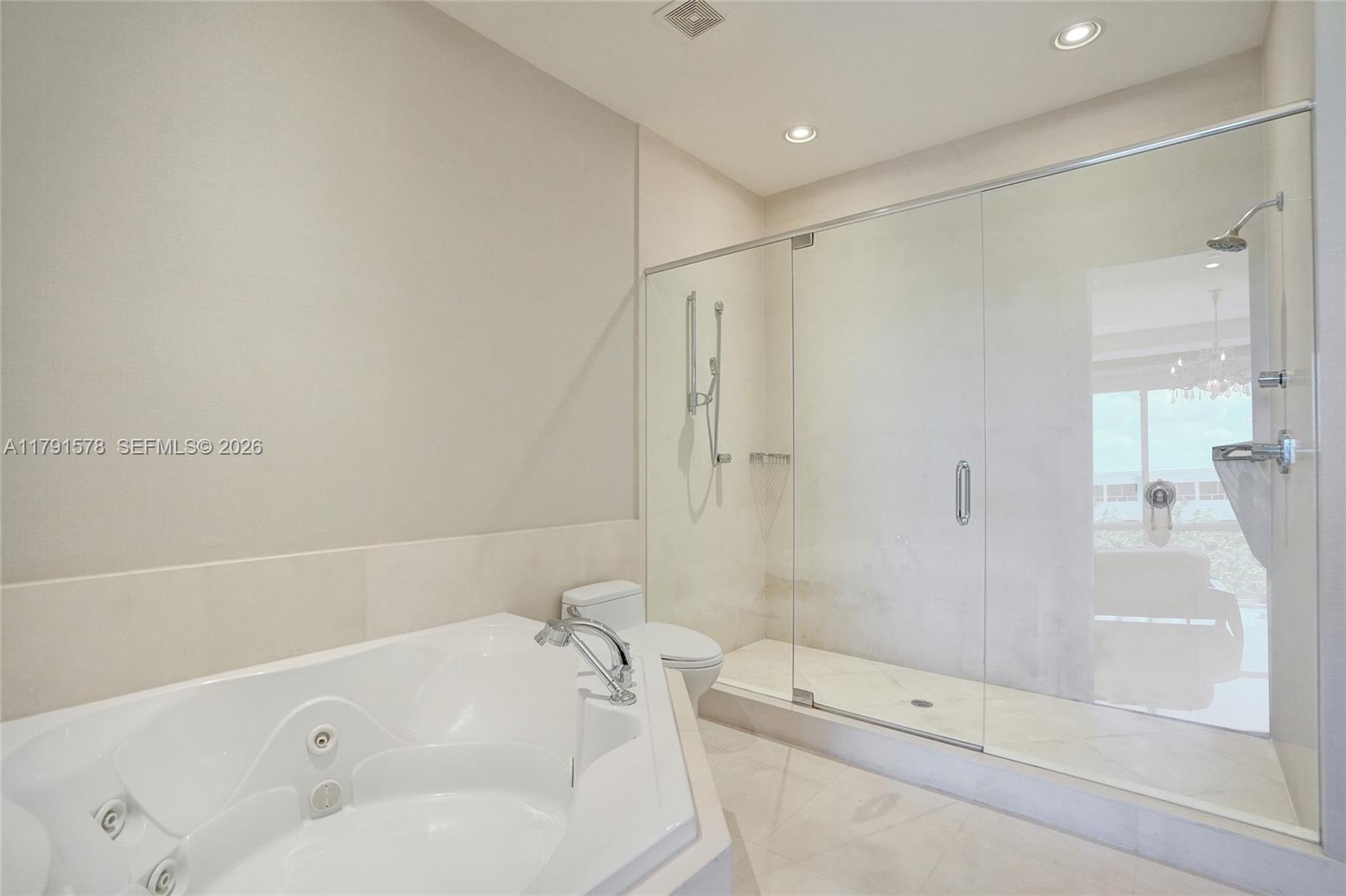 2725 Northeast 1st Street Pompano Beach, FL 33062 - Photo 38 of 59 a bathroom with a tub and a shower