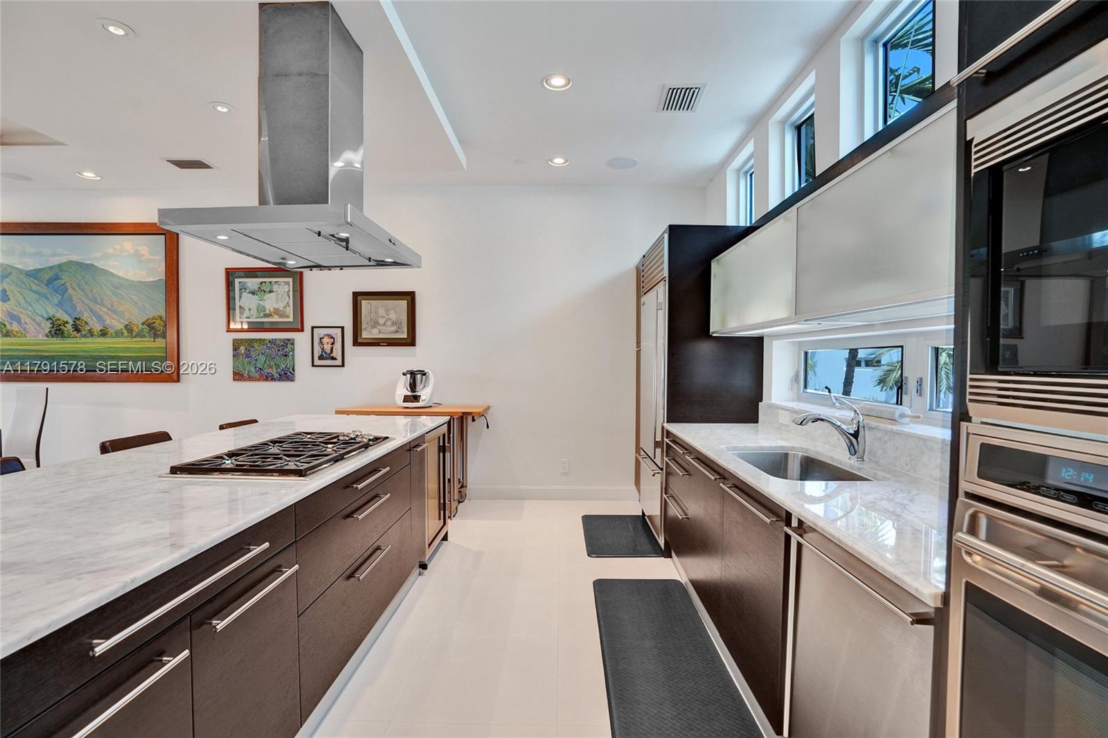 2725 Northeast 1st Street Pompano Beach, FL 33062 - Photo 4 of 59 a kitchen with stainless steel appliances granite countertop a stove and a sink