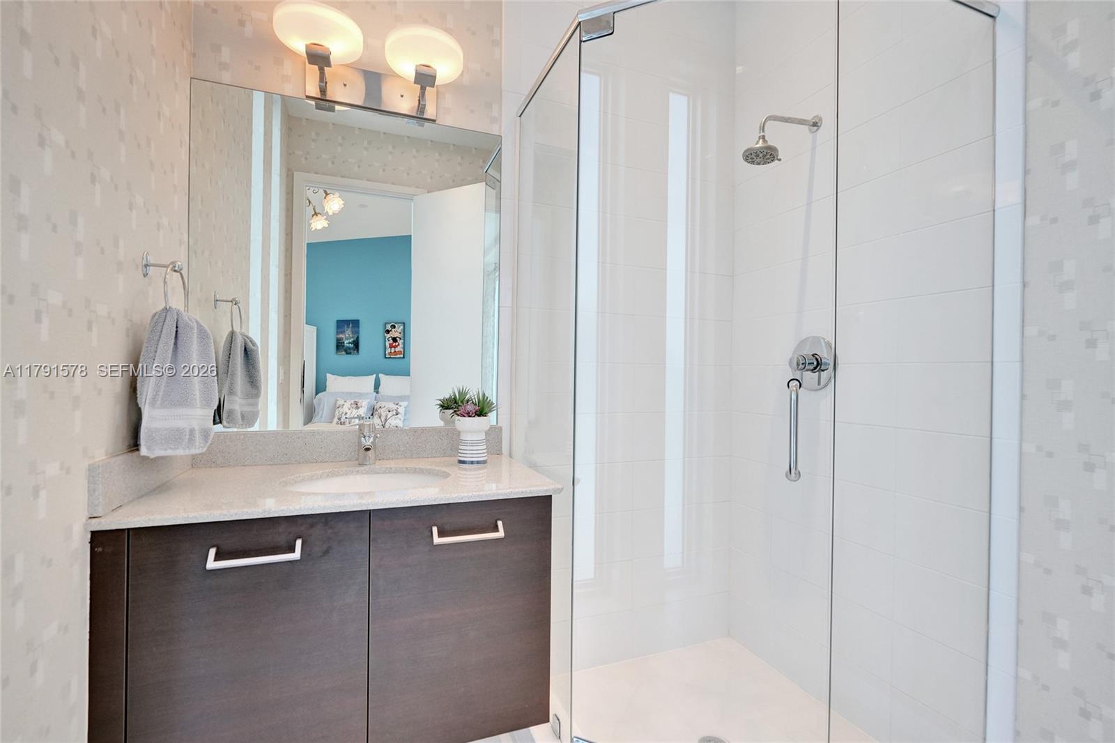 2725 Northeast 1st Street Pompano Beach, FL 33062 - Photo 41 of 59 a bathroom with a sink vanity granite shower and a mirror