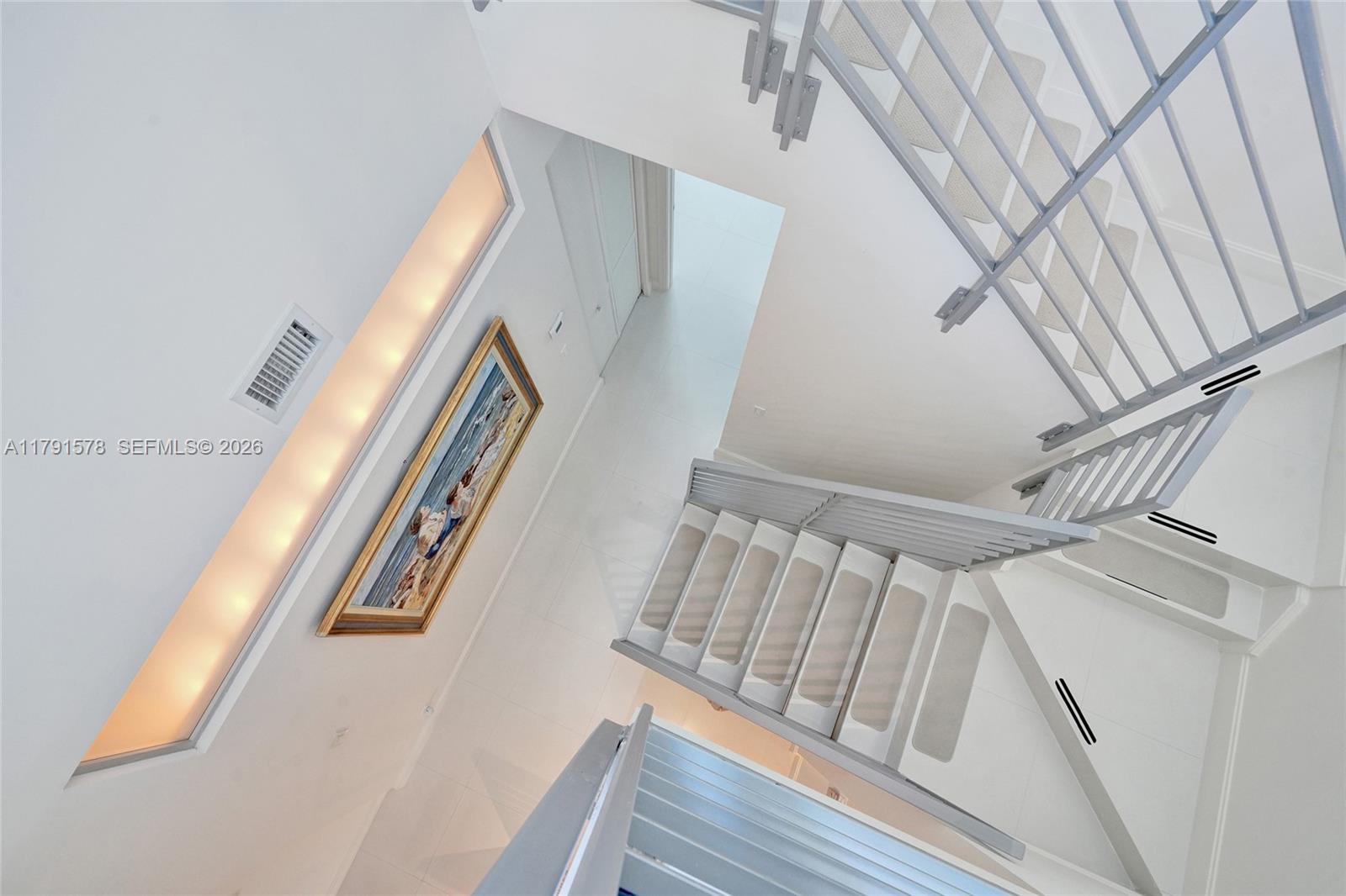 2725 Northeast 1st Street Pompano Beach, FL 33062 - Photo 43 of 59 a view of staircase with white walls and a window