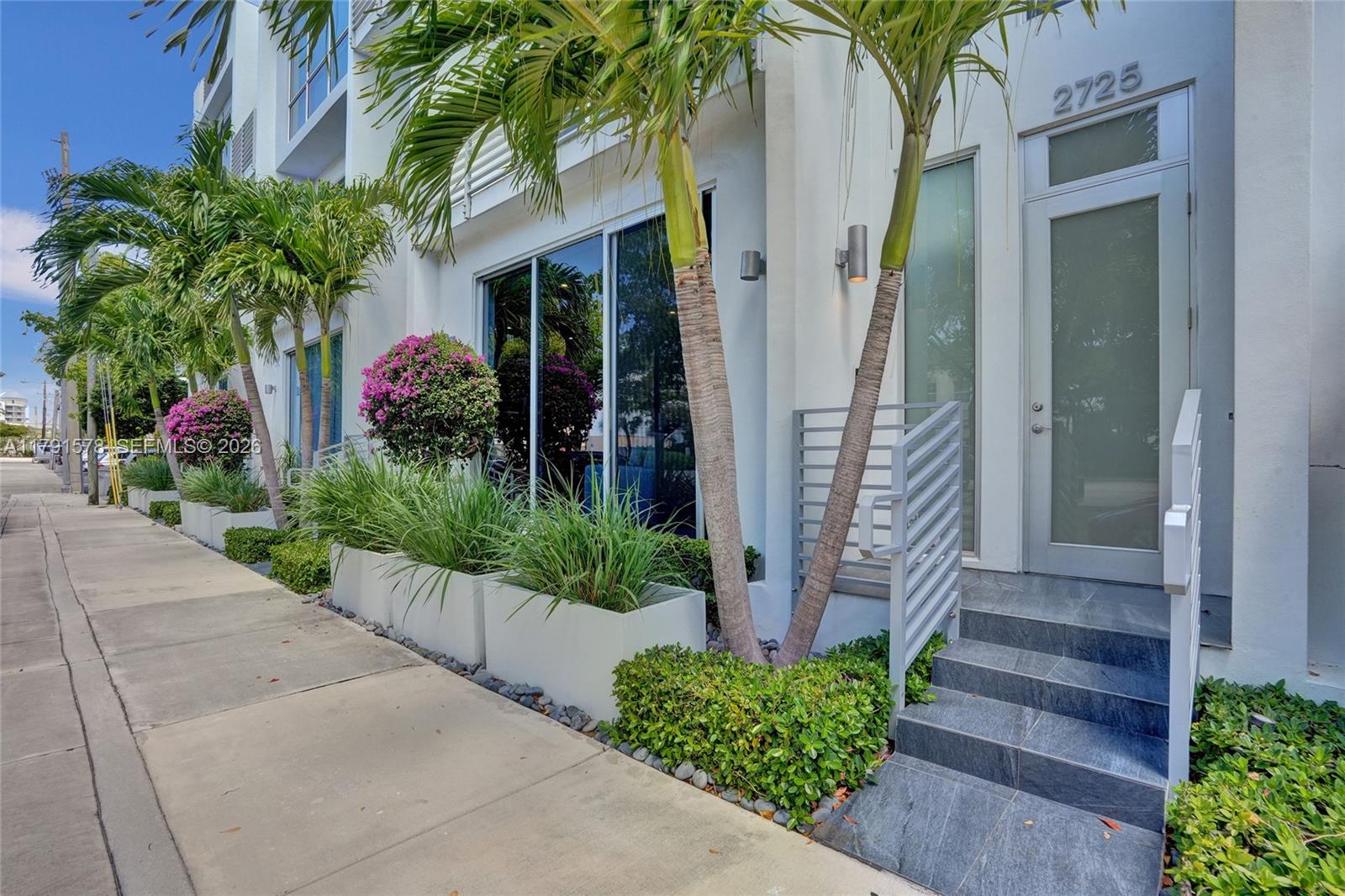 2725 Northeast 1st Street Pompano Beach, FL 33062 - Photo 10 of 59 a front view of a house with a garden