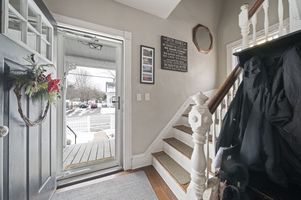 73 Monroe Street Abington, MA 02351 - Photo 14 of 28 a view of staircase with lots of frames on wall and a window