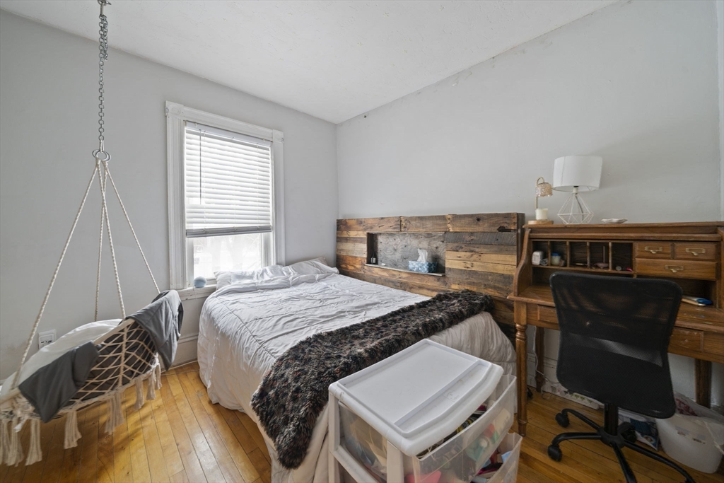 73 Monroe Street Abington, MA 02351 - Photo 17 of 28 a bed sitting in a bedroom next to a window