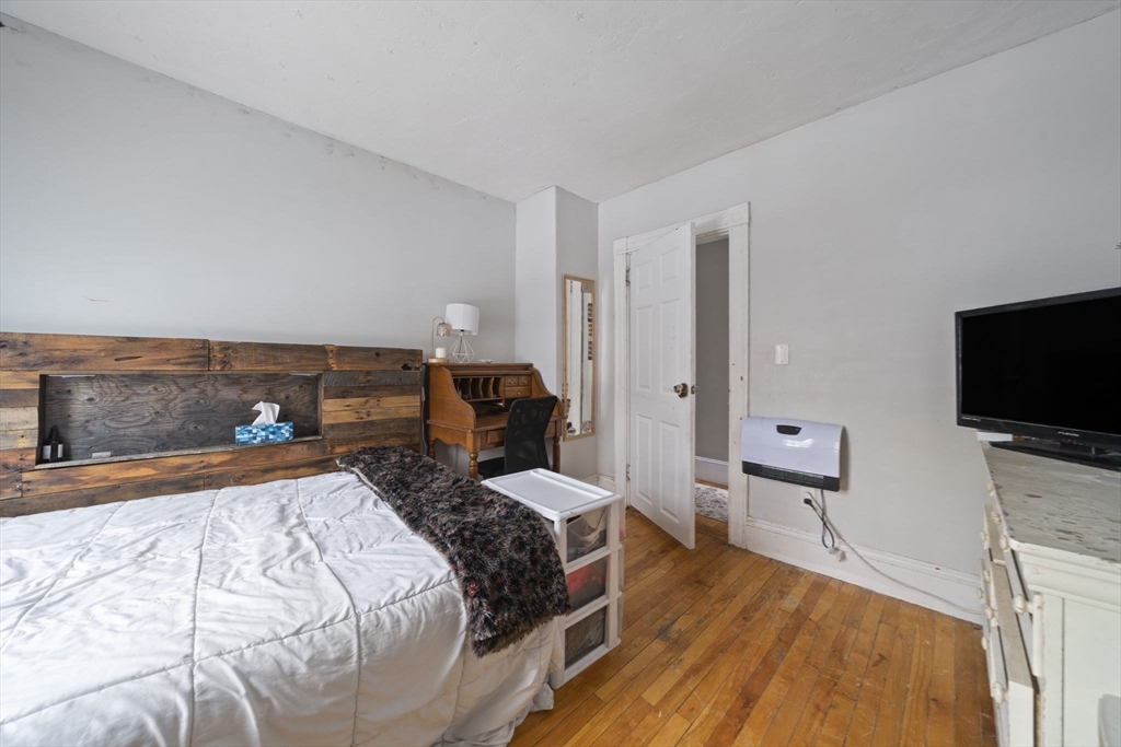 73 Monroe Street Abington, MA 02351 - Photo 18 of 28 a bed room with a bed and a television