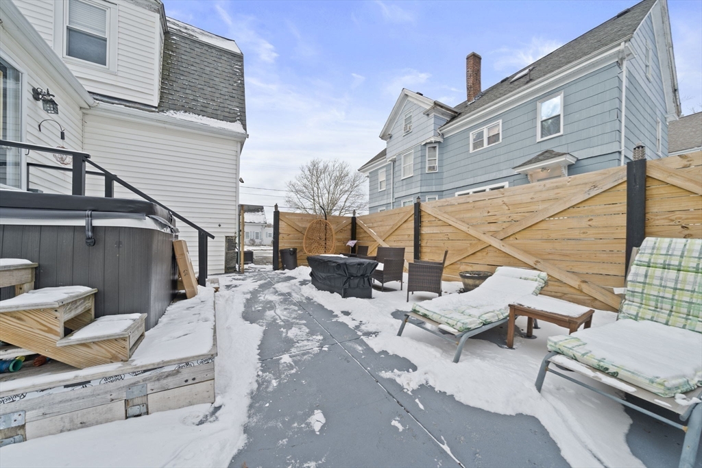 73 Monroe Street Abington, MA 02351 - Photo 27 of 28 a view of a patio with a table and chairs