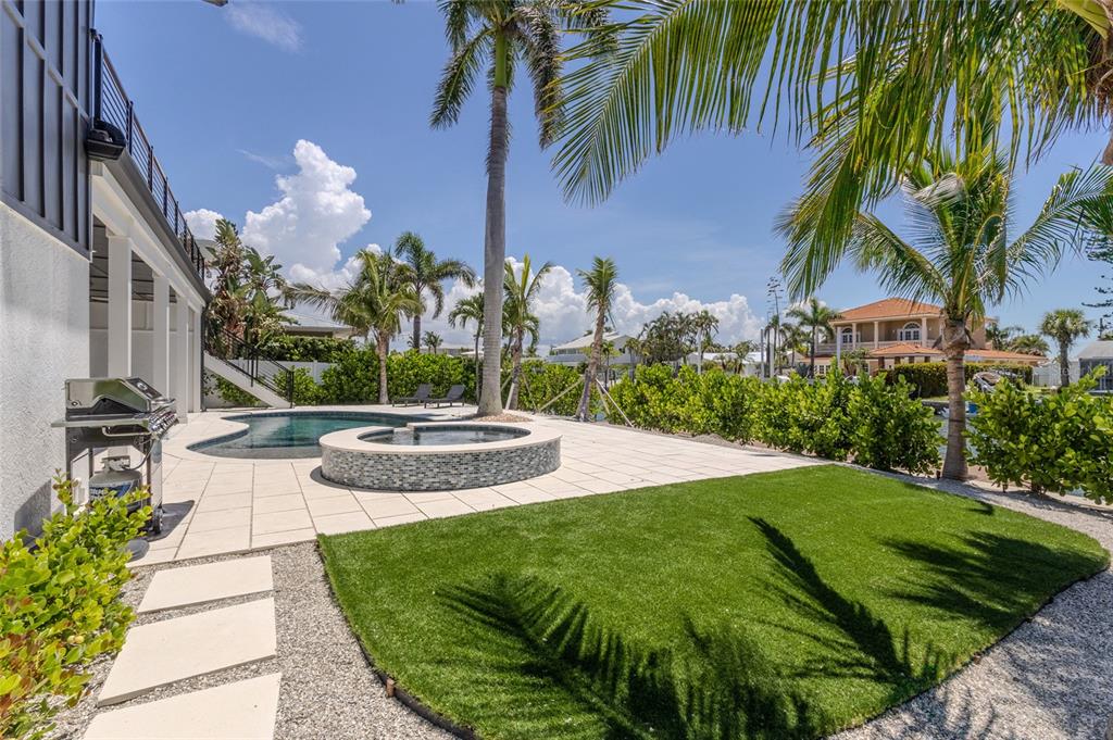 405 28th Street Holmes Beach, FL 34217 - Photo 14 of 50 a view of a swimming pool with a garden