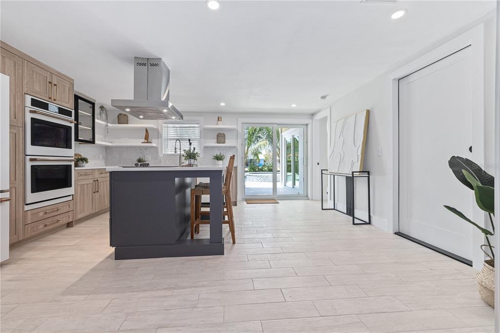 405 28th Street Holmes Beach, FL 34217 - Photo 16 of 50 a view of kitchen with stainless steel appliances wooden floor and window