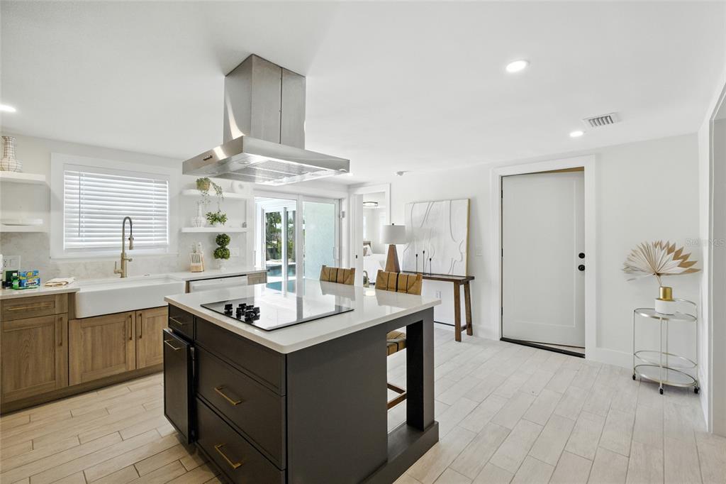 405 28th Street Holmes Beach, FL 34217 - Photo 19 of 50 a kitchen with stainless steel appliances a stove a sink dishwasher and a refrigerator with wooden floor