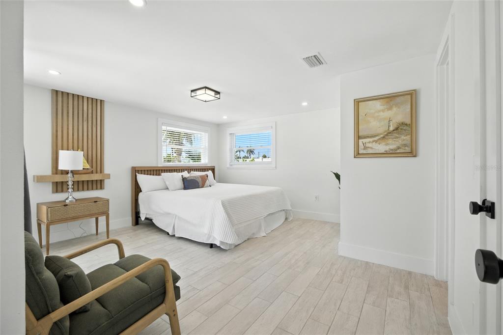 405 28th Street Holmes Beach, FL 34217 - Photo 24 of 50 a spacious bedroom with a bed and glass window