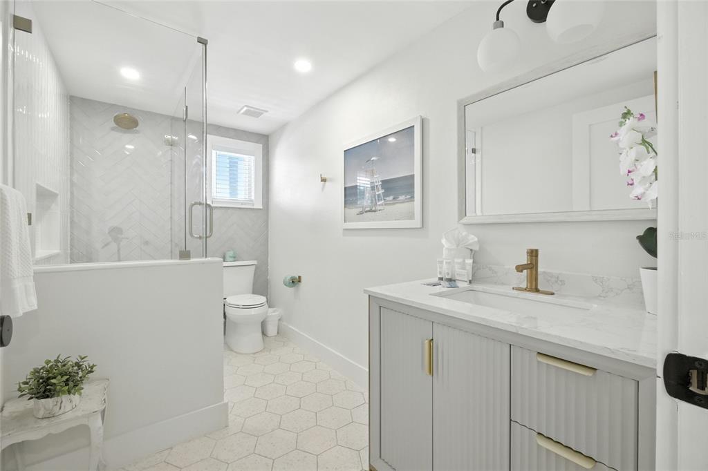 405 28th Street Holmes Beach, FL 34217 - Photo 28 of 50 a bathroom with a granite countertop sink mirror and toilet