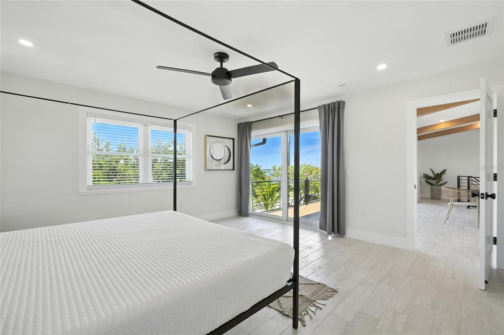 405 28th Street Holmes Beach, FL 34217 - Photo 36 of 50 a bedroom with a bed next to a window