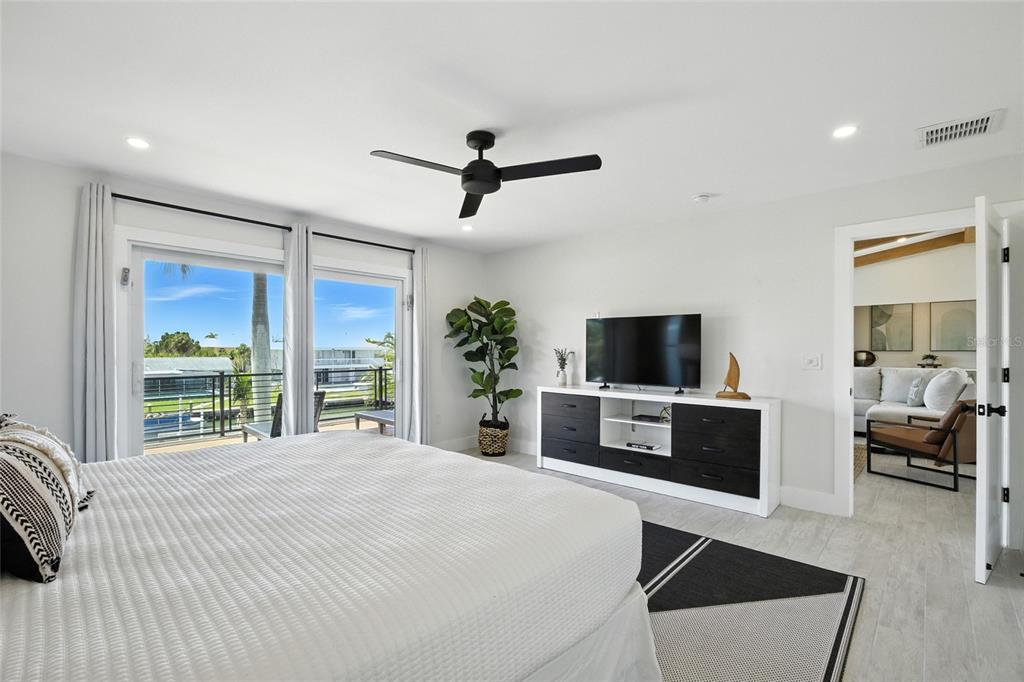 405 28th Street Holmes Beach, FL 34217 - Photo 38 of 50 a bedroom with a bed and a flat screen tv