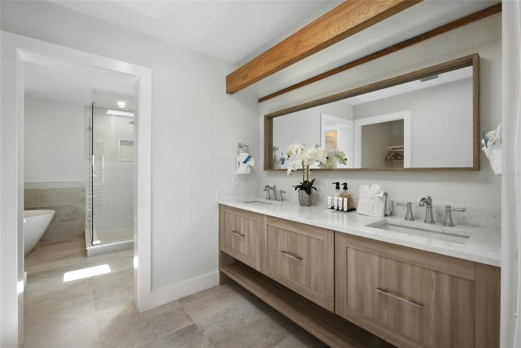 405 28th Street Holmes Beach, FL 34217 - Photo 39 of 50 a bathroom with a double vanity sink and mirror