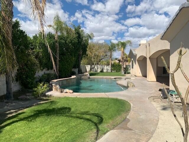 21 Napoleon Road Rancho Mirage, CA 92270 - Photo 14 of 20 a view of a swimming pool with a yard