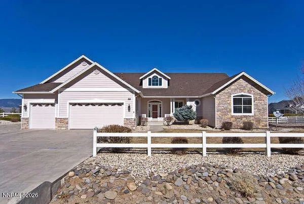a view of a house with a yard and wooden fence