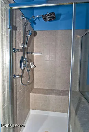 a spacious bathroom with a granite countertop sink a mirror a bathtub and a shower