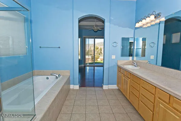 an empty room with wooden floor closet and chandelier fan
