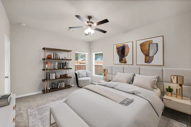 a bedroom with a large bed a couch and a book shelf
