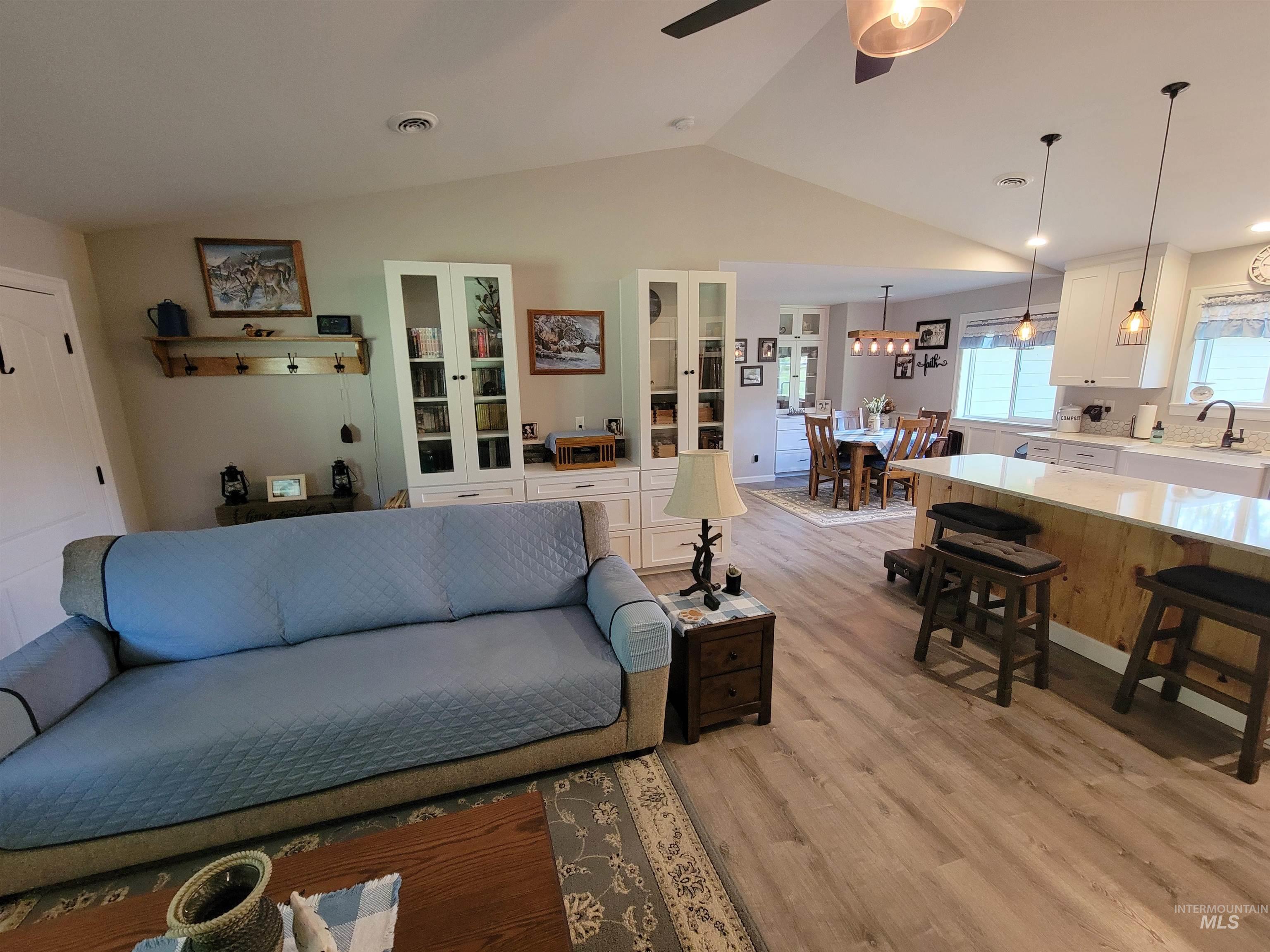 437 Clearcreek Road Kooskia, ID 83539 - Photo 16 of 45 Living room featuring vaulted ceiling, light wood finished floors, and a ceiling fan
