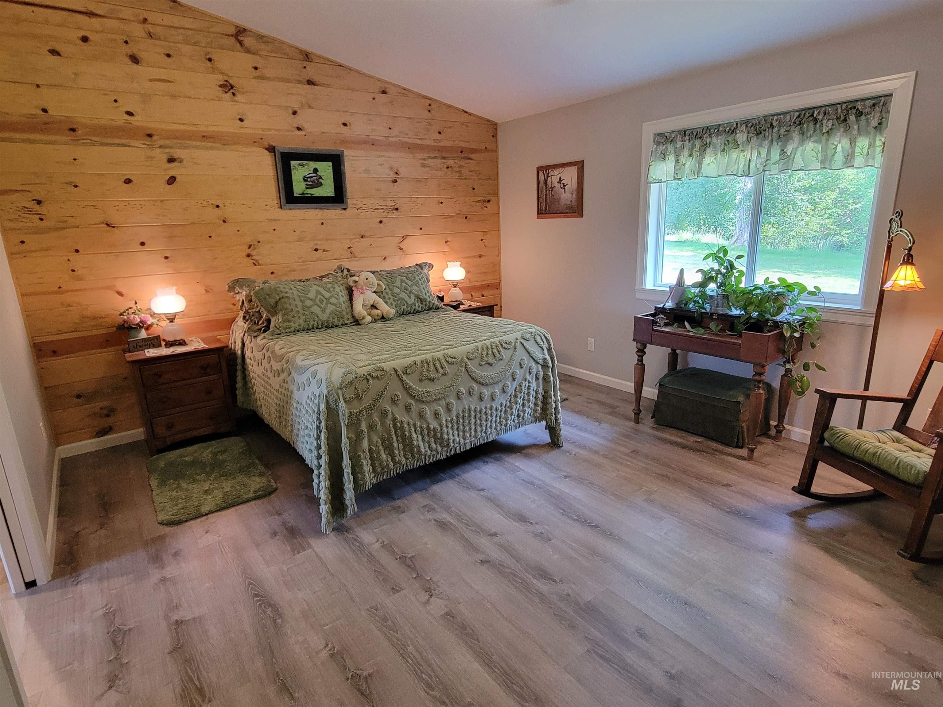 437 Clearcreek Road Kooskia, ID 83539 - Photo 17 of 45 Bedroom with wood finished floors, lofted ceiling, and wood walls