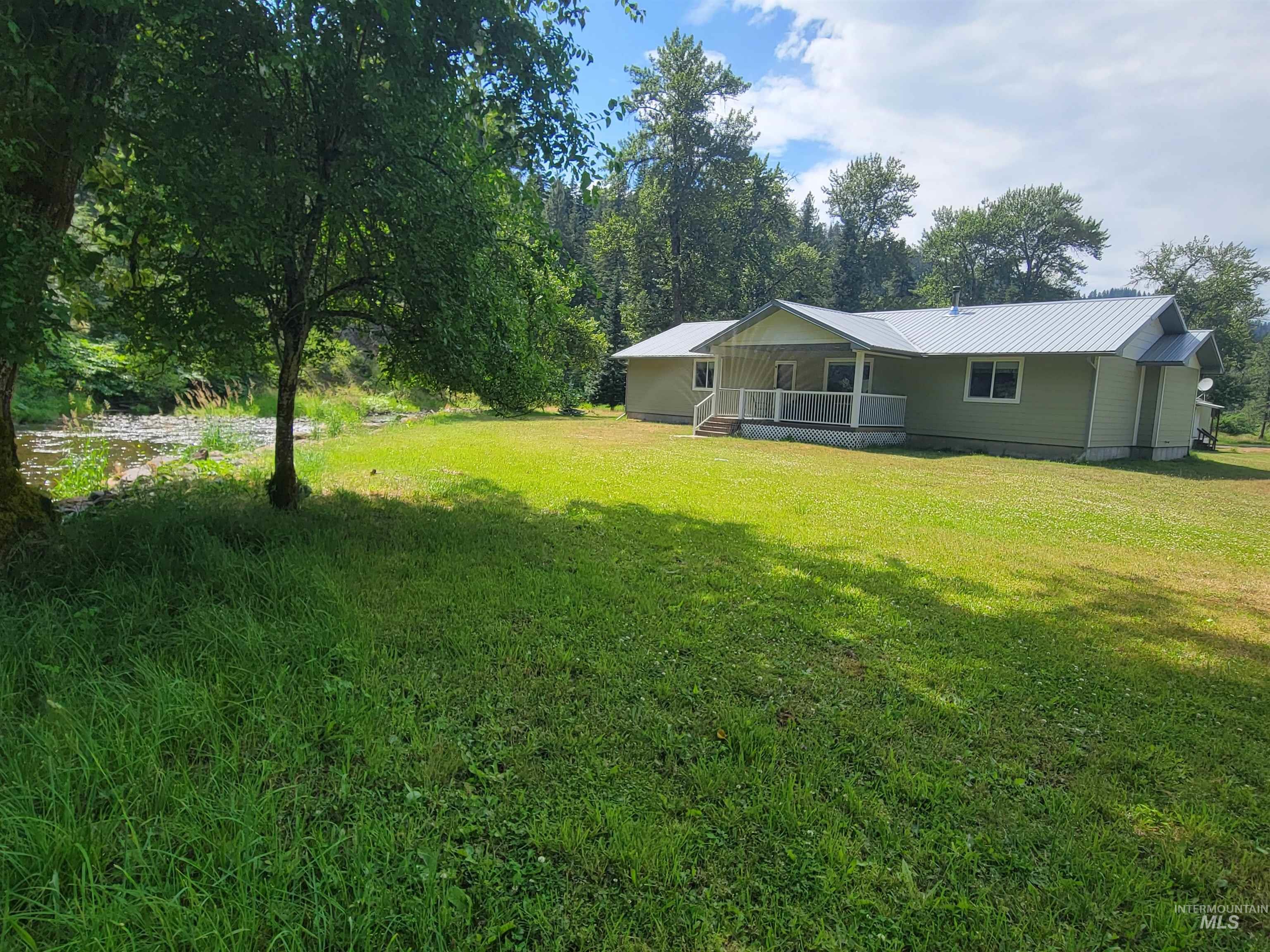 437 Clearcreek Road Kooskia, ID 83539 - Photo 2 of 45 View of grassy yard featuring covered porch