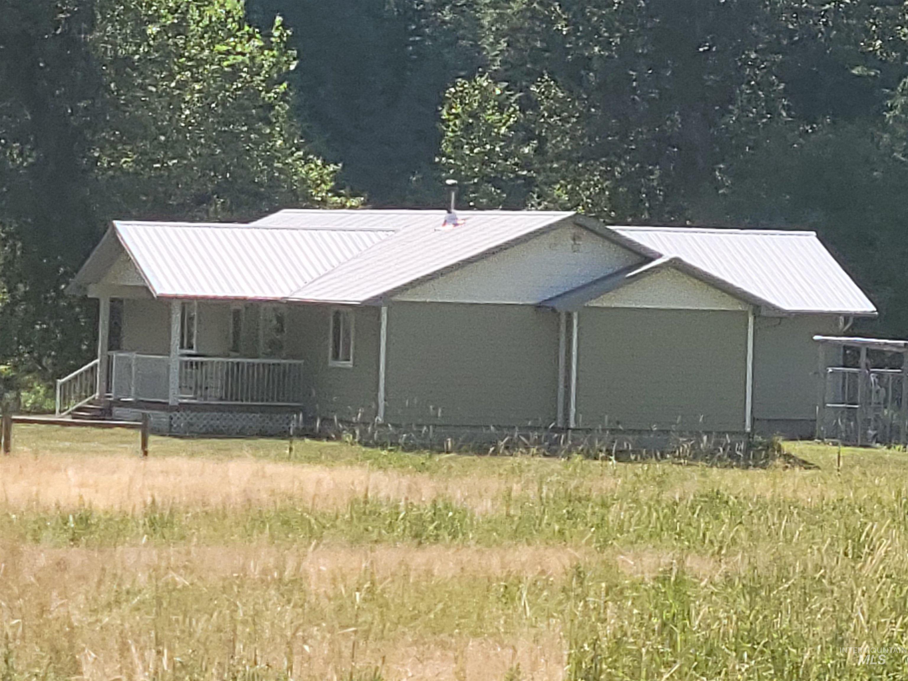437 Clearcreek Road Kooskia, ID 83539 - Photo 3 of 45 View of front facade featuring a metal roof and covered porch