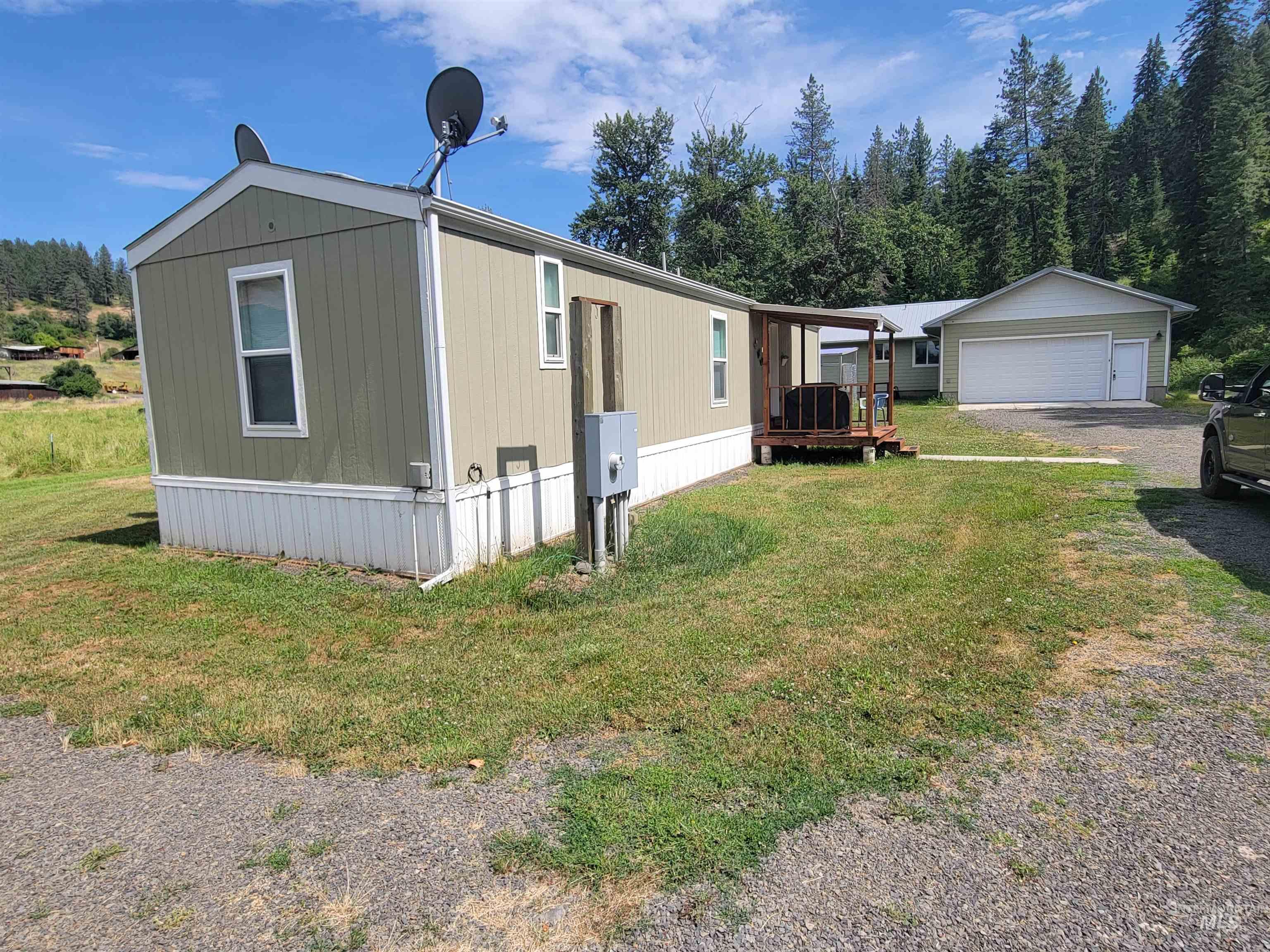 437 Clearcreek Road Kooskia, ID 83539 - Photo 35 of 45 View of front of home featuring a garage, an outdoor structure, and a front lawn