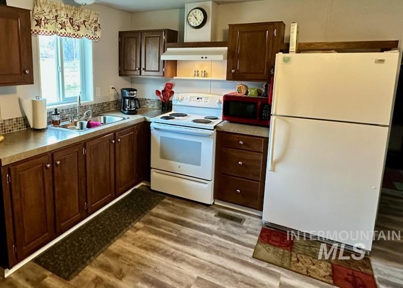 437 Clearcreek Road Kooskia, ID 83539 - Photo 40 of 45 Kitchen featuring white appliances, light wood-type flooring, and light countertops