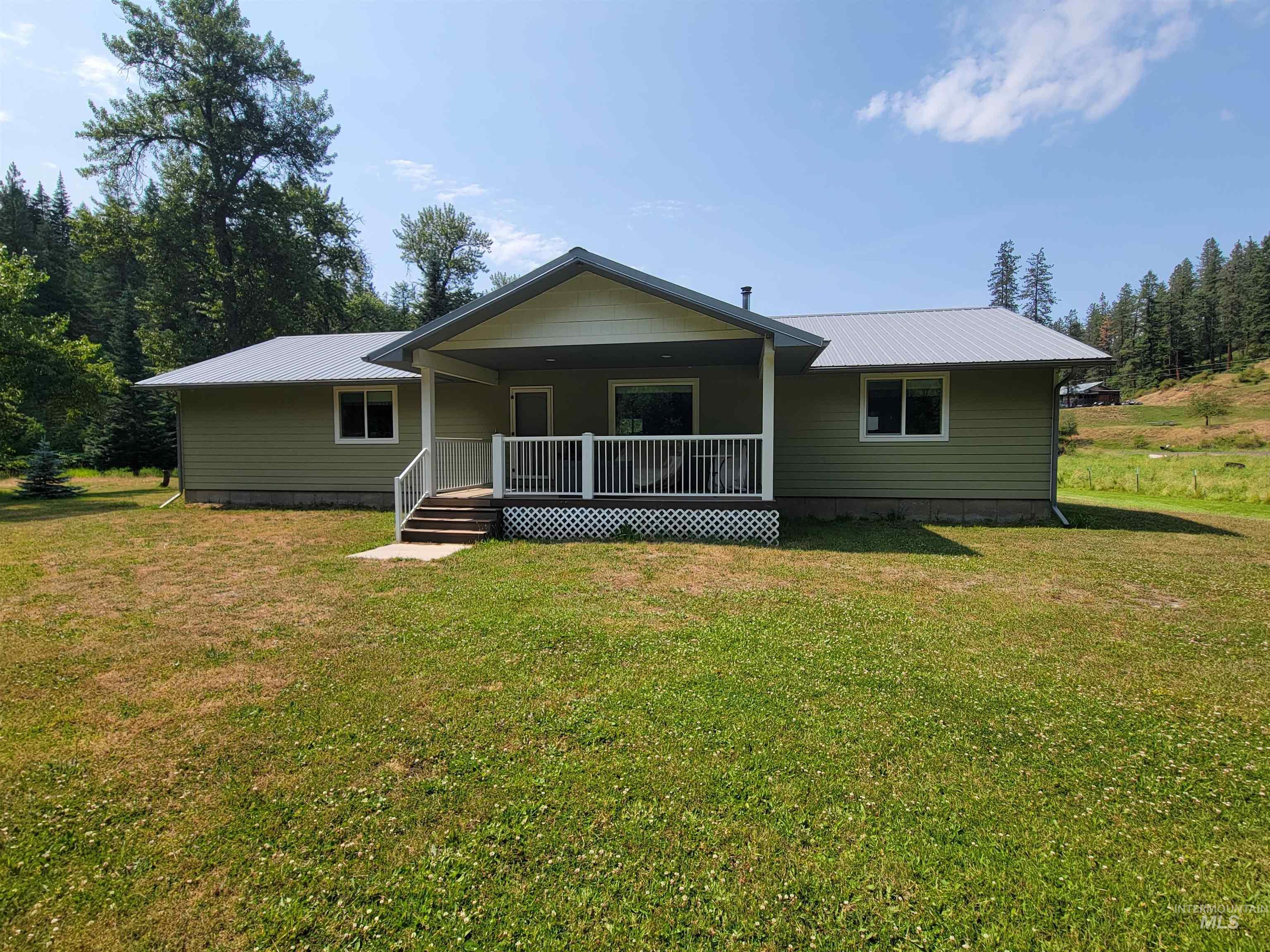 437 Clearcreek Road Kooskia, ID 83539 - Photo 4 of 45 View of front of property with covered porch, a metal roof, and a front lawn