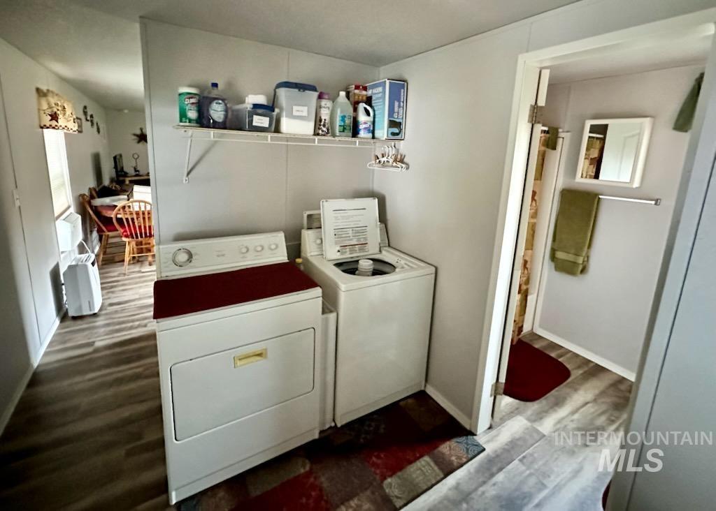 437 Clearcreek Road Kooskia, ID 83539 - Photo 42 of 45 Laundry room featuring dark wood-type flooring and washer and clothes dryer