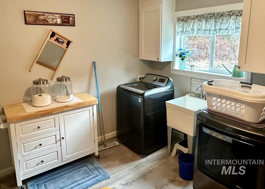 437 Clearcreek Road Kooskia, ID 83539 - Photo 45 of 45 Laundry area featuring cabinet space and light wood-type flooring