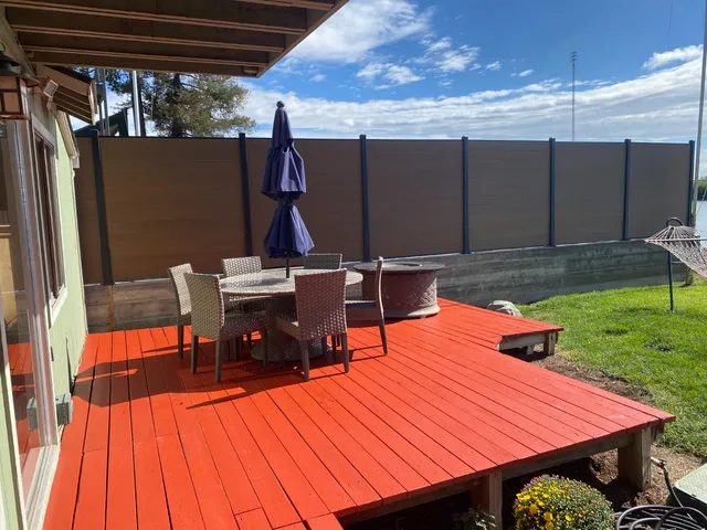 a wooden bench sitting in front of a house